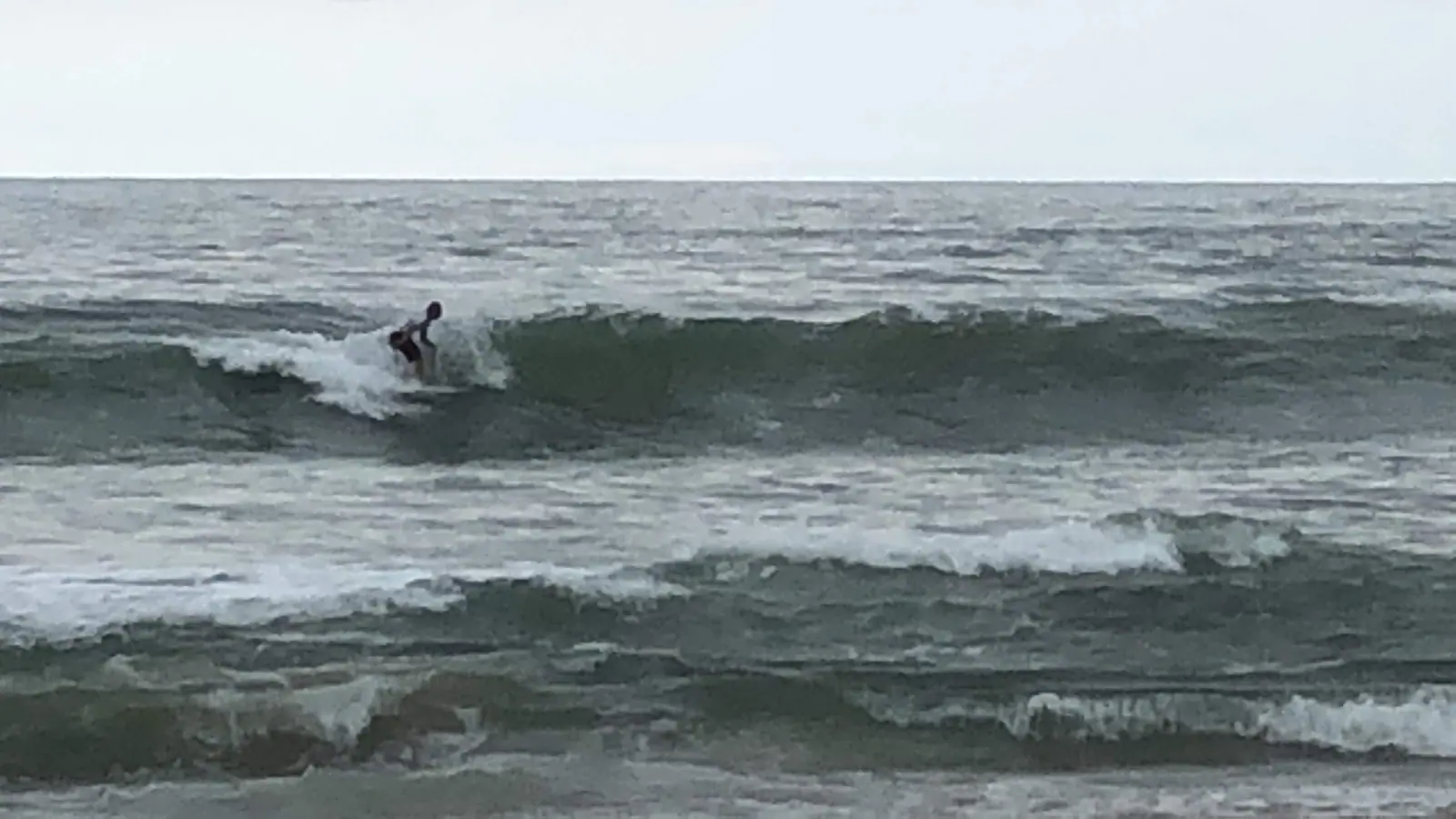 Surfista pegando onda em Maresias num dia de mar agitado