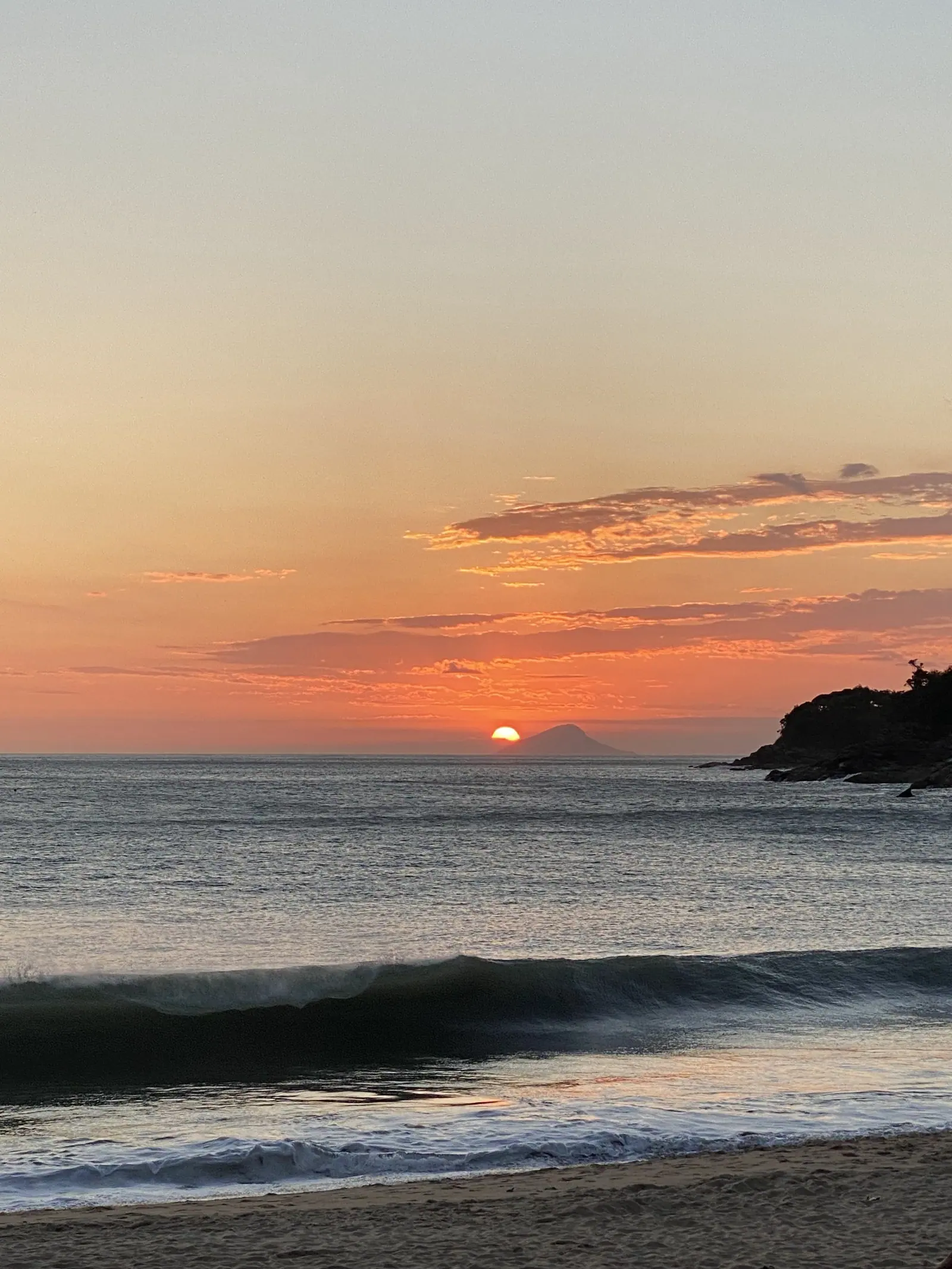 Onda quebrando na praia de Toque-Toque Grande com o sol no horizonte